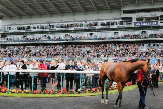 LEGER LOVE-IN -- the packed stands at Doncaster on Saturday when more than 25,000 flocked to Town Moor to see a dramatic Ladbrokes St Leger.