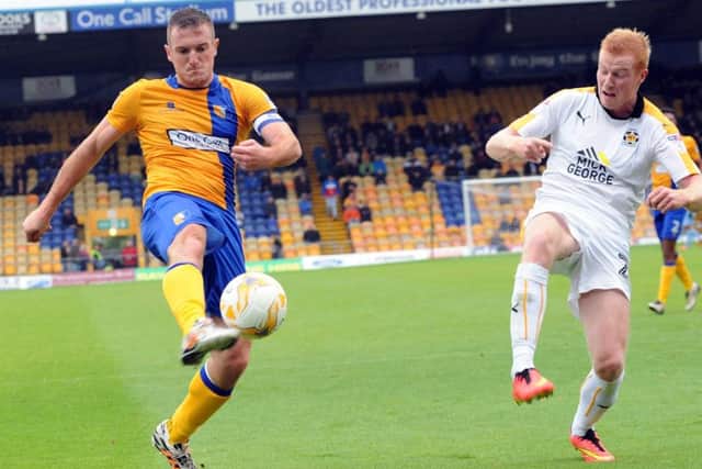 Mansfield Town v CambridgeStags' captain, Lee Collins, puts the last cross of the first half into the Cambridge box.