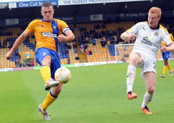 Mansfield Town v Cambridge
Stags' captain, Lee Collins, puts the last cross of the first half into the Cambridge box.