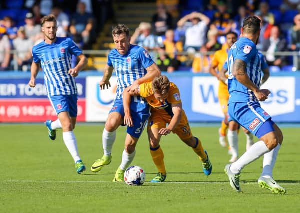 Mansfield Town's Danny Rose is brought down on the half way line - Pic by Chris Holloway