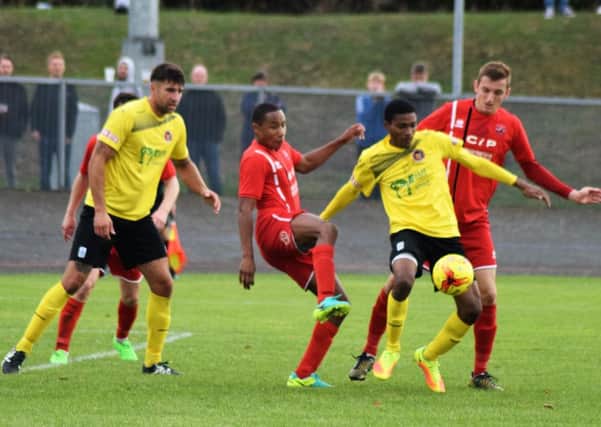 Action from AFC Mansfield (in red) against Stamford on Saturday. Photo by Peter Craggs.