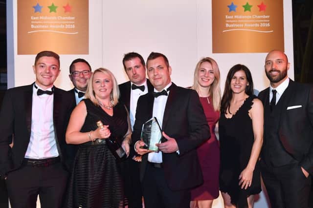 Managing director Matt Wheatcroft, centre, holding trophy, and the Purpose Media team celebrate the award win.
