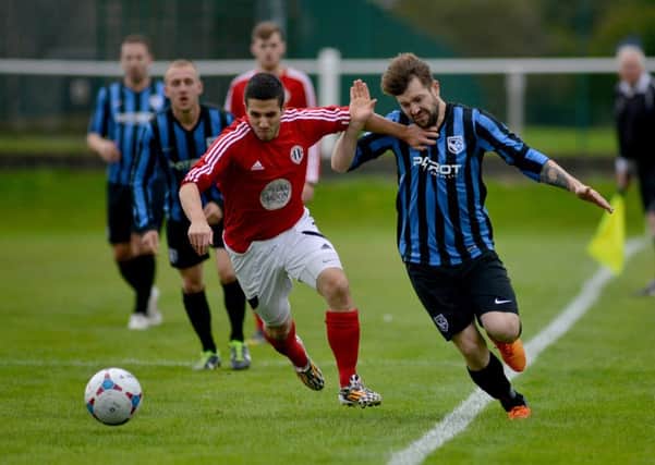 Wayne Cooke (right) in action for Selston against Southwell City last weekend. Photo by Rachel Atkins.