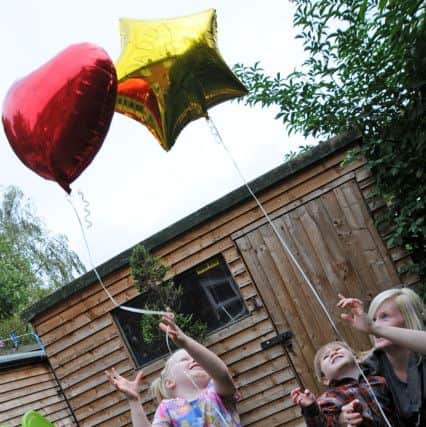 Helen Darby and her children Enya and Wesley, release balloons with messages of love for their dad Nathan.
