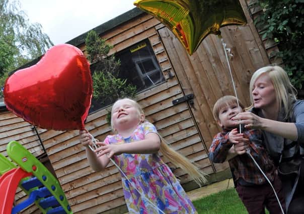 Helen Darby and her children Enya and Wesley, release balloons with messages of love for their dad Nathan.