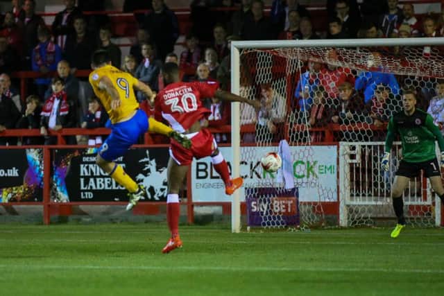 Mansfield Town's Patt Hoban heads for goal - Pic by Chris Holloway