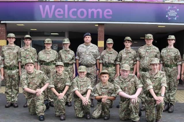 ALL KITTED OUT -- cadets and adult volunteers of the new Combined Cadet Force, pictured outside Sutton Community Academy.