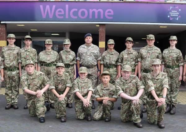 ALL KITTED OUT -- cadets and adult volunteers of the new Combined Cadet Force, pictured outside Sutton Community Academy.