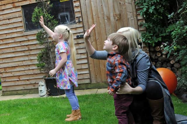 Helen Darby and her children Enya and Wesley, release balloons with messages of love for their dad Nathan.