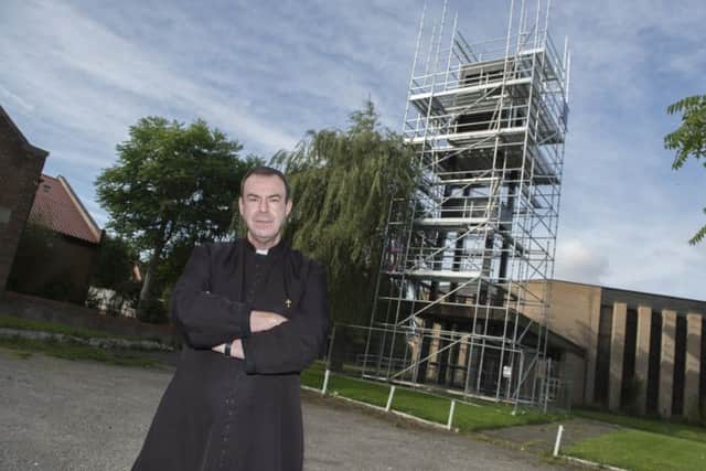 Father Nicolas Spicer outside St PaulÃ¢Â¬"s Church, Pelham Street, Worksop. Scaffolding on the bell tower is proving expensive as they try to tackle the pigeon problem. Picture: Sarah Washbourn