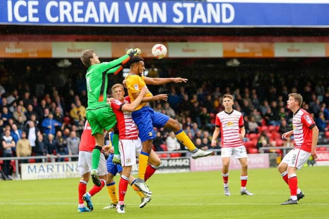 Mansfield Town's Rhys Bennet battles with the Crewe defence - Pic by Chris Holloway