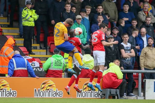 Mansfield Town's Danny Rose jumps high to head the ball - Pic by Chris Holloway