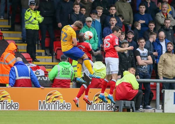 Mansfield Town's Danny Rose jumps high to head the ball - Pic by Chris Holloway