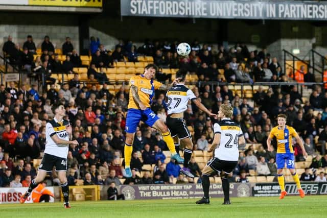 Mansfield Town's Darius Henderson wins the header  - Pic by Chris Holloway