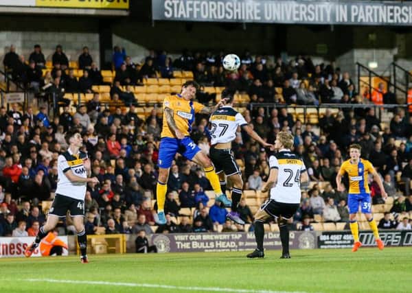 Mansfield Town's Darius Henderson wins the header  - Pic by Chris Holloway