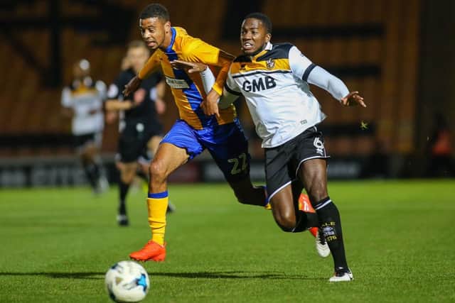 Mansfield Town's CJ Hamilton heads for goal - Pic by Chris Holloway