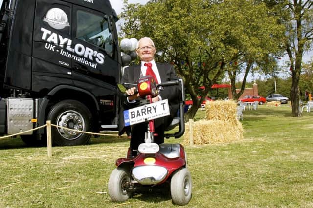 Barry Taylor next to a  special truck painted  to celebrate 40 years for B. Taylor And Sons Transport Ltd and 10 years for Taylors Transport International Ltd.