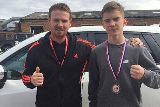PACKING A PUNCH -- England Box Cup champion Marcus Ellis (right) with his coach at Huthwaite Amateur Boxing Club, Chris Jowett.