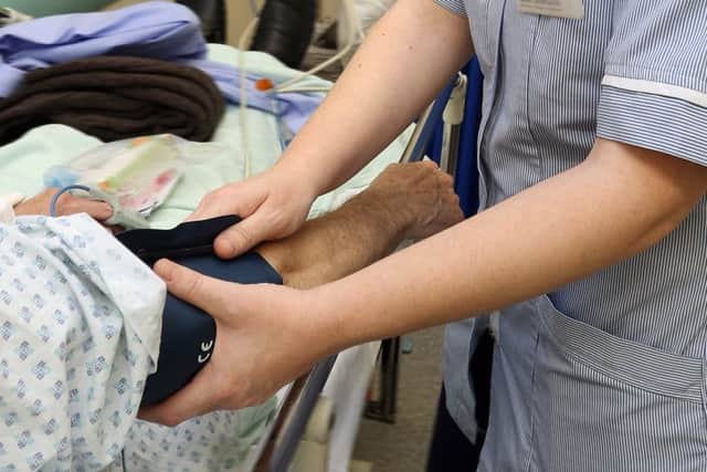 stock hospital A+E, taking a patients blood pressure