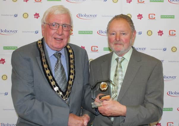 COMMUNITY CHAMPION -- Neville Hardy, 79, of South Normanton Colts FC, receives his community award from council chairman, Coun Ken Walker.