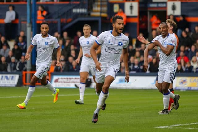Mansfield Town's Matt Green turns to face the travelling fans after opening the scoring against Luton Town - Pic by Chris Holloway