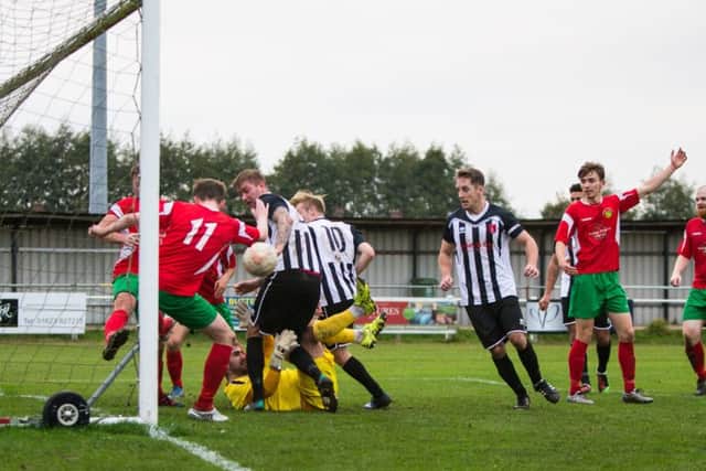 SO CLOSE -- Harrogate Railway Athletic defenders scramble the ball to safety as Clipstone go hunting for goals during their Northern Counties East League, Premier Division clash.
