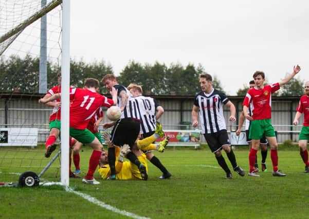 SO CLOSE -- Harrogate Railway Athletic defenders scramble the ball to safety as Clipstone go hunting for goals during their Northern Counties East League, Premier Division clash.