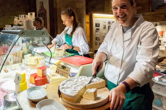 FESTIVAL FANCIES -- smiles from behind the counter at one of the many food stalls at the Bramley Apple Festival. (PHOTO BY: Richard Jarvis)