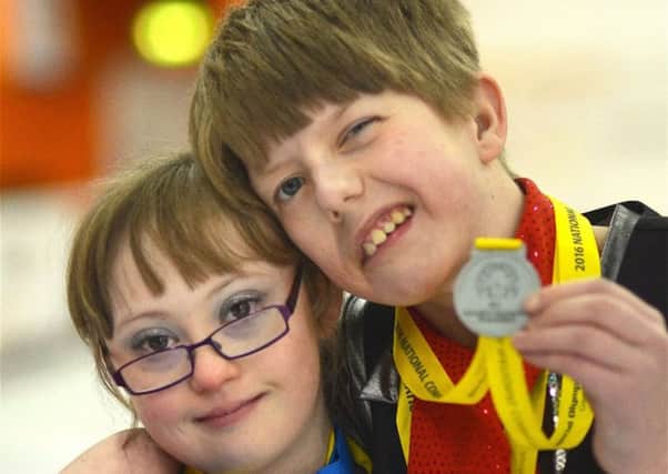 SPORTING CHAMPIONS -- medal-happy figure-skating duo Meg McFarlane and Callum Mills.