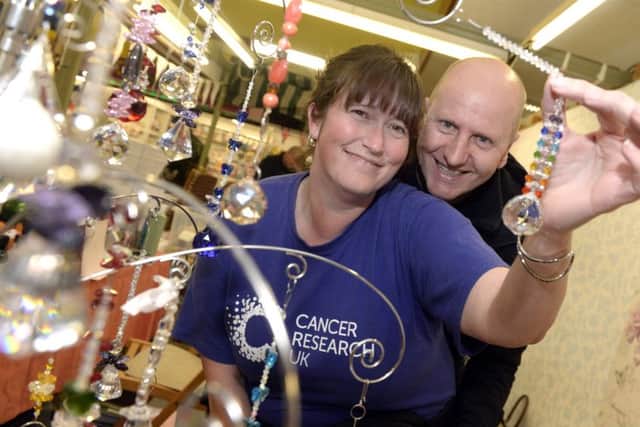 MARKET SPARKLE -- Sandra Bellamy and Peter Abrahall on one of the stalls at the indoor market's craft fair.