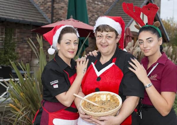Lauren Billings, Annie Savage and Danielle Alton mixing a Christmas Pudding at the Cherry Tree Farm