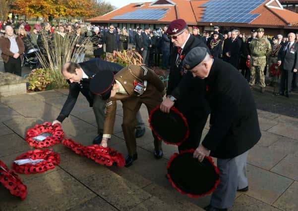 Serving and former servicemen lay their wreaths.