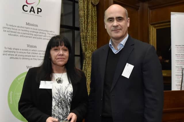 GOOD GRIEF! -- Sue Grief, the scourge of under-age drinking, receives her award from CAP director Nick Grant.
