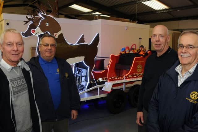 Rotarians, Terry Moult, Robert Copley, Andrew Stone and Allan Johnson with the Christmas sleigh which has been refurbished with new lighting thanks to Hucknall's Oshino Light Ltd.