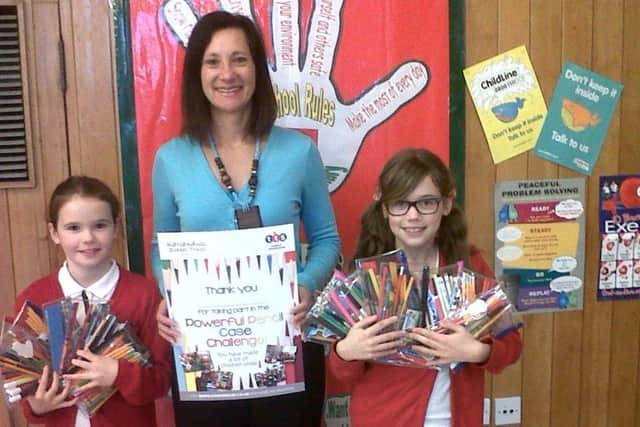 MAKING A CASE FOR KENYA -- Jo Shelley, of TTS, with two of the schoolchildren who took part in the challenge.