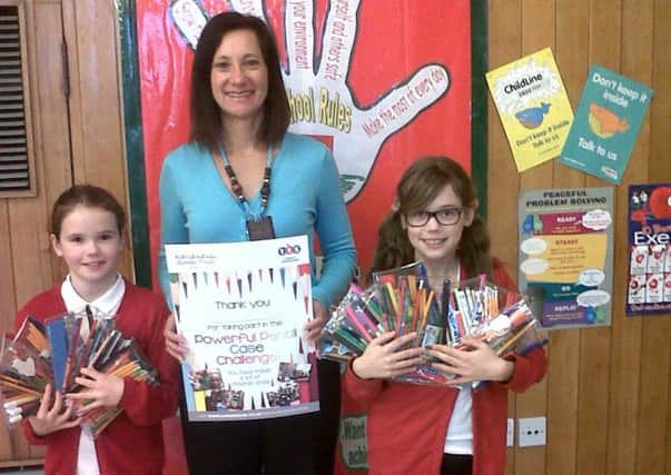 MAKING A CASE FOR KENYA -- Jo Shelley, of TTS, with two of the schoolchildren who took part in the challenge.