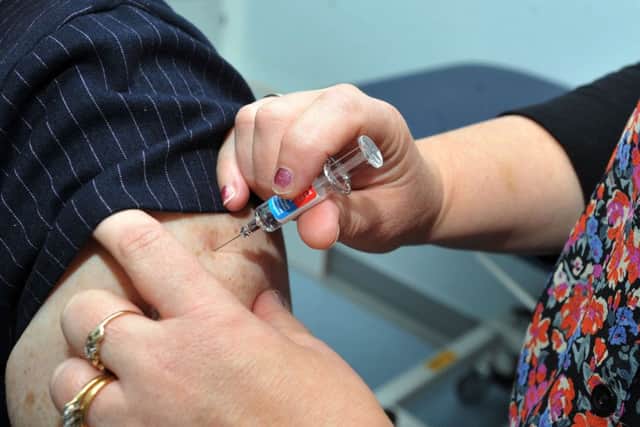 Nurse practitioner Julie Balmer, right, injects Doctor Kate Ardern, as she gets a flu jab to promote campaign to get members of the public vaccinated against the flu virus, at Worsley Mesnes Health Centre, Wigan.