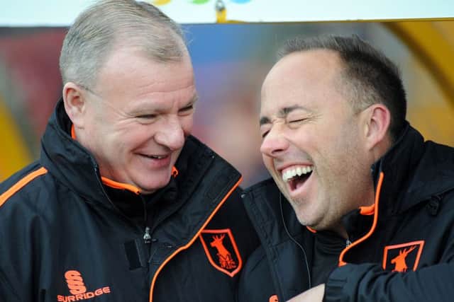 Steve Evans shares a joke with new fitness coach Lee Taylor in the dug out on Saturday.
