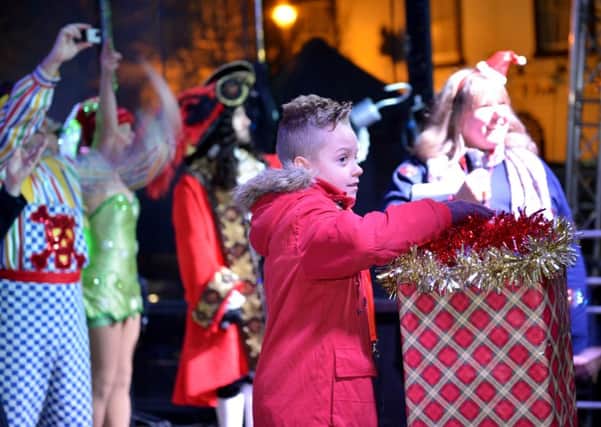 THE BIG SWITCH-ON -- eight-year-old Jaidon Boucher switches on the lights.