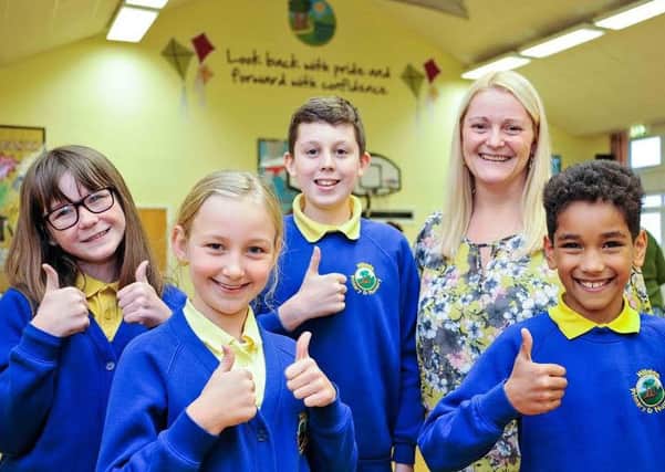 From left, Abigail Mould, Fern Hatcher, Max Dunn, Head Teacher Rhian Richardson and Elijah Oprych celebrate Hillside Primary School's "good" Ofsted report.