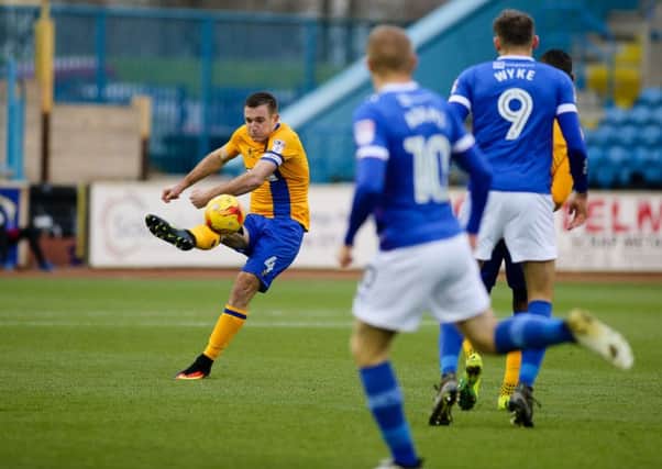Mansfield Town's Lee Collins clears at the back - Pic by Chris Holloway