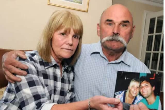 Sharon and Geoff Winter hold a photograph of their son Luke.