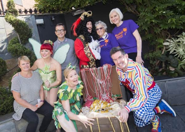 Members of the panto cast with staff, fundraisers and volunteers from the hospice.