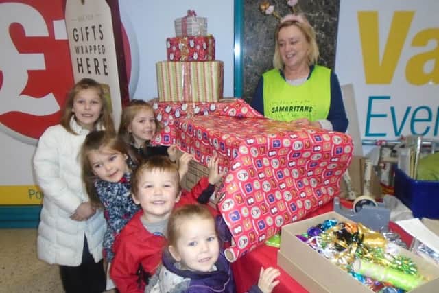 Youngsters supporting Samaritans gift-wrapping service at Four Seasons.