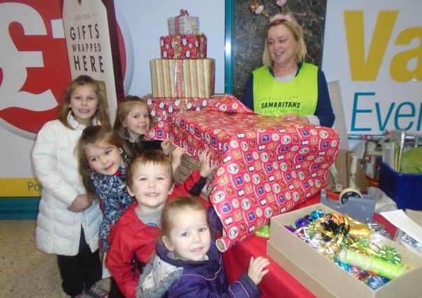 Youngsters supporting Samaritans gift-wrapping service at Four Seasons.