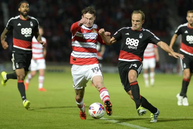 Liam Mandeville and David Vaughan challenge for the ball.Doncaster Rovers v Nottingham Forest. EFL Cup 1st round.  9 August 2016.  Picture Bruce Rollinson