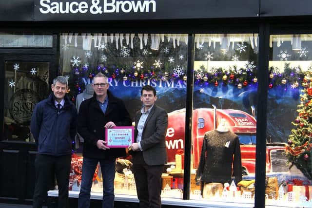 Andrew Frogson, of Sauce & Brown, receives his award after the clothing store was crowned joint winner.