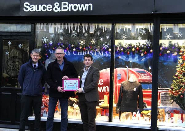 Andrew Frogson, of Sauce & Brown, receives his award after the clothing store was crowned joint winner.