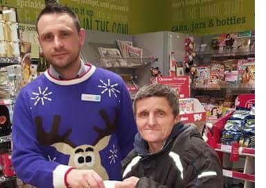 Co-op deputy manager Russ Wilson gives unsung hero Robert Shelton a festive goodie bag