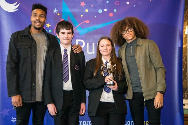 Diversity members Jordan Banjo, left, and Perri Kiely, right, with members of Sutton Community Academy's court team.